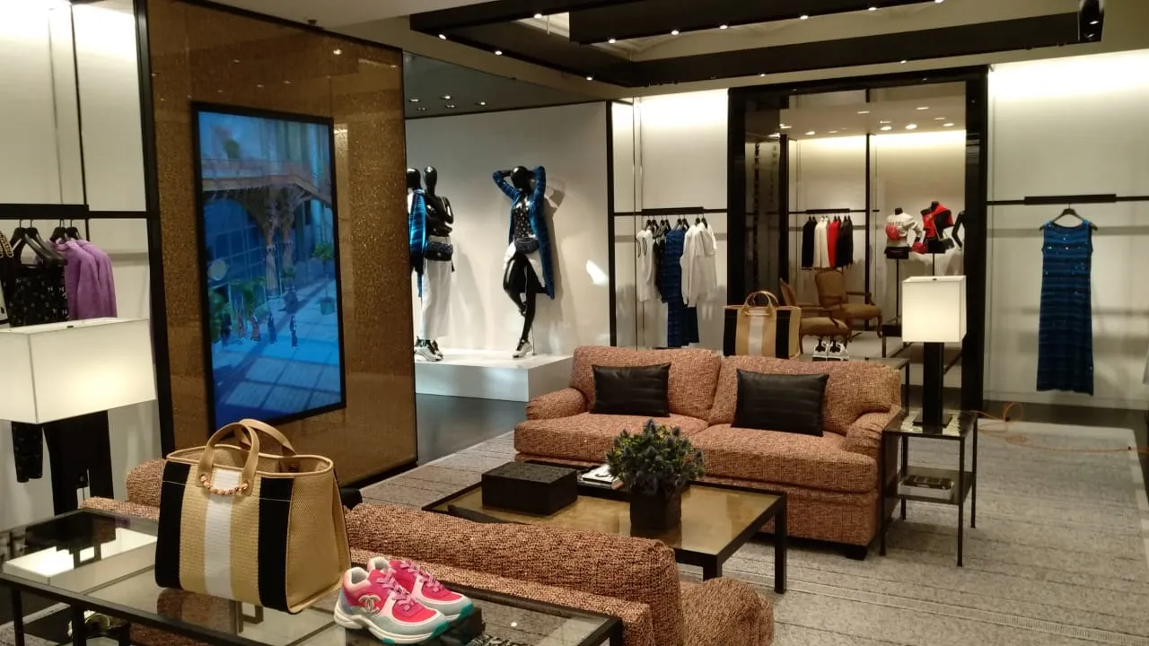 Open-air marina terrace with navy and white patterned loungers, teak decking, and parasol shading